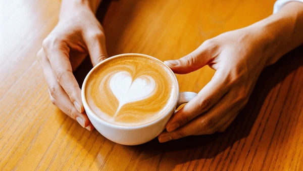 Hands cradling coffee